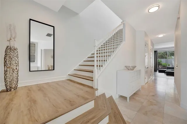a spacious bedroom with a bed and wooden floor