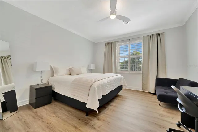 a view of a patio with couches table and chairs with wooden floor