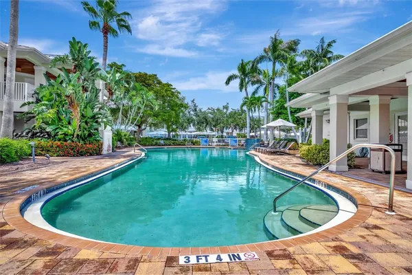 a view of a lake with lawn chairs and a table and chairs