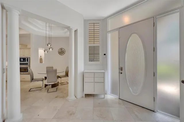 a kitchen with white cabinets and appliances