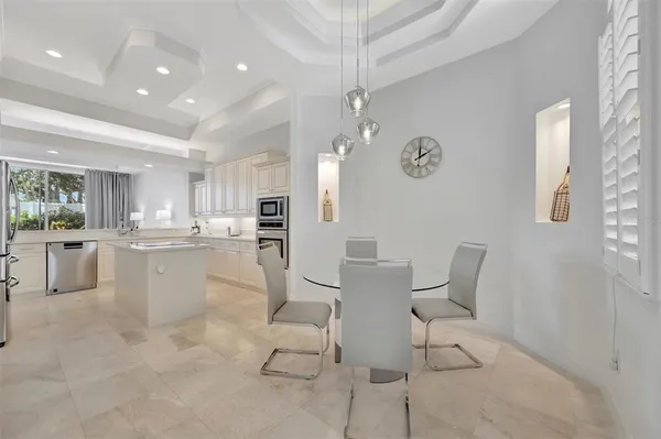 a kitchen with white cabinets and white appliances