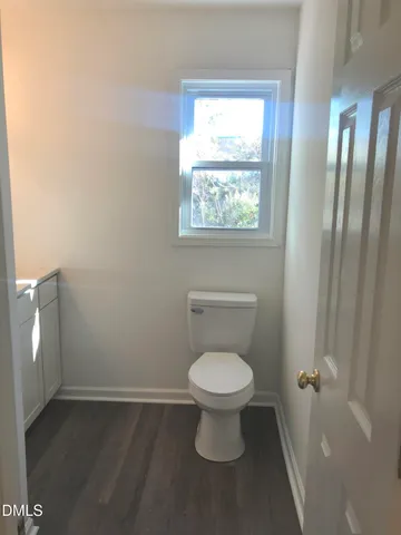 a bathroom with a toilet sink and window