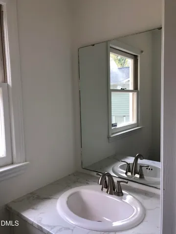 a bathroom with a sink and a window
