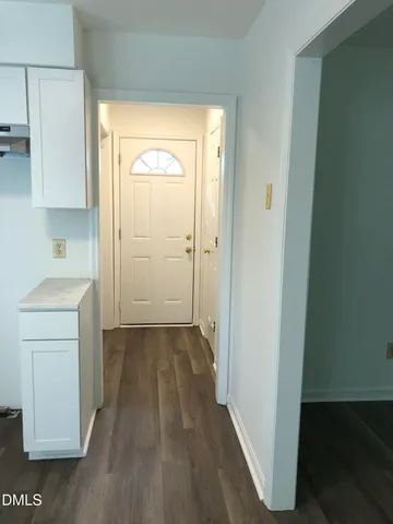 a view of hallway with wooden floor