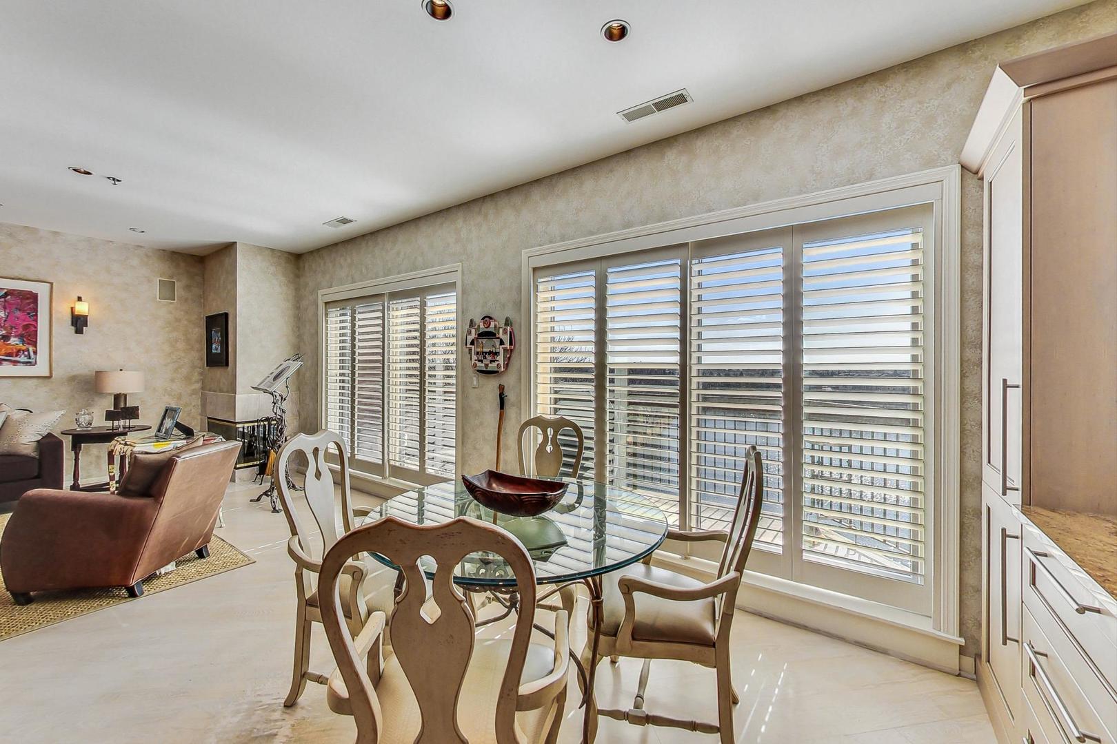 209 Rivershire Lane, Unit 503 Lincolnshire, IL 60069 - Photo 14 of 53 a living room with furniture and floor to ceiling windows
