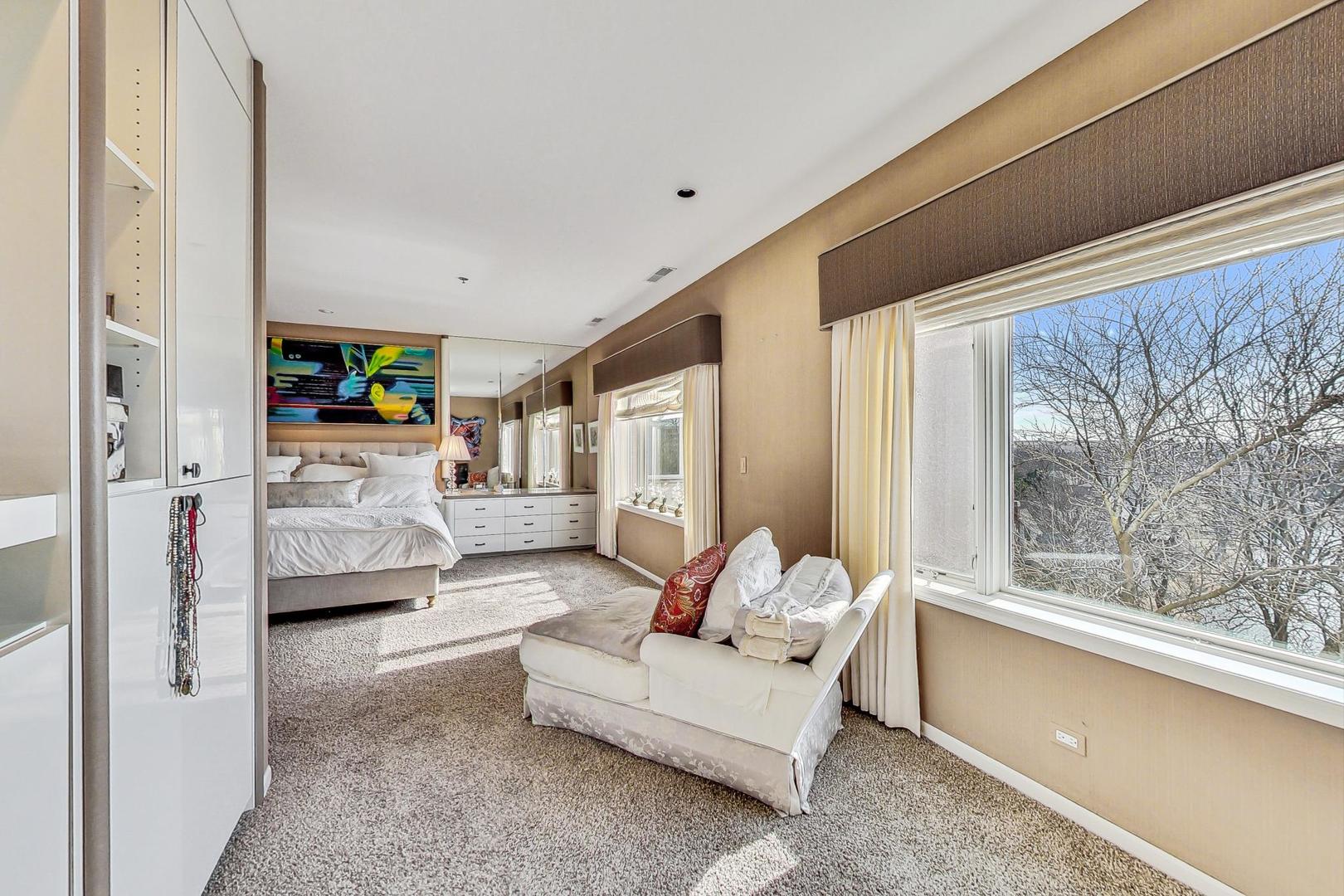 209 Rivershire Lane, Unit 503 Lincolnshire, IL 60069 - Photo 23 of 53 a bedroom with furniture and a large window