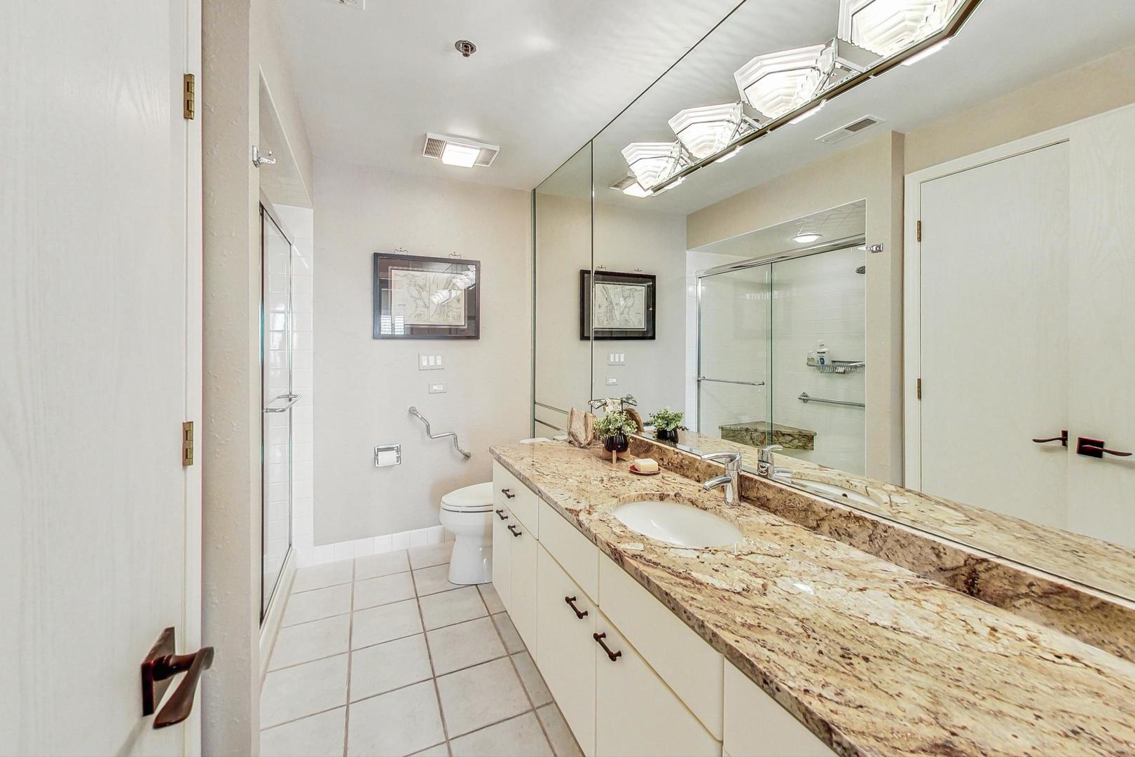 209 Rivershire Lane, Unit 503 Lincolnshire, IL 60069 - Photo 29 of 53 a spacious bathroom with a granite countertop sink mirror and a shower