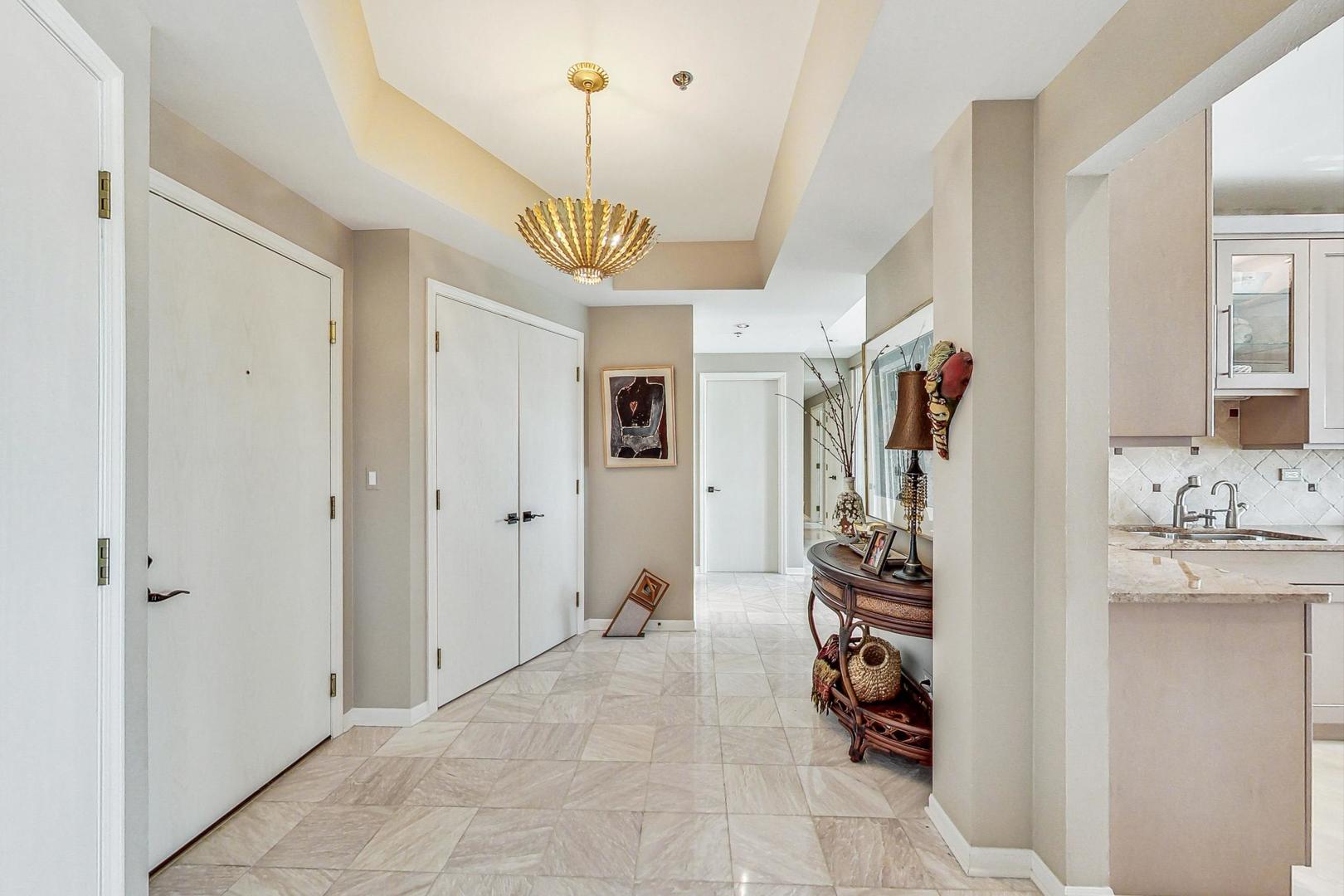 209 Rivershire Lane, Unit 503 Lincolnshire, IL 60069 - Photo 5 of 53 a view of a hallway to a bedroom and a livingroom