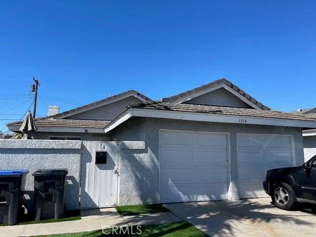 a front view of a house with parking space