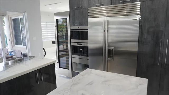 a view of a patio with chairs and potted plants