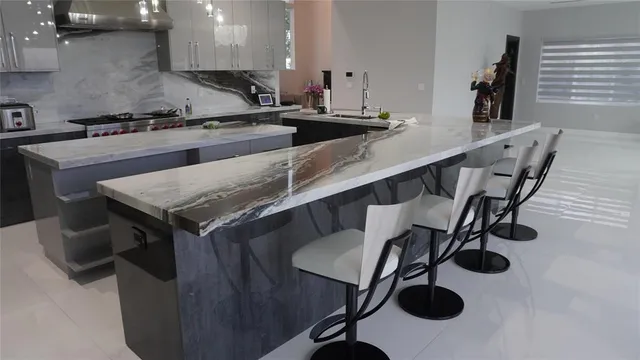 a bathroom with a granite countertop toilet and a sink