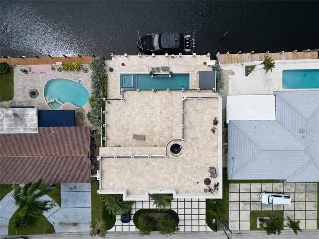 a view of a patio with couches and table potted plants and palm trees