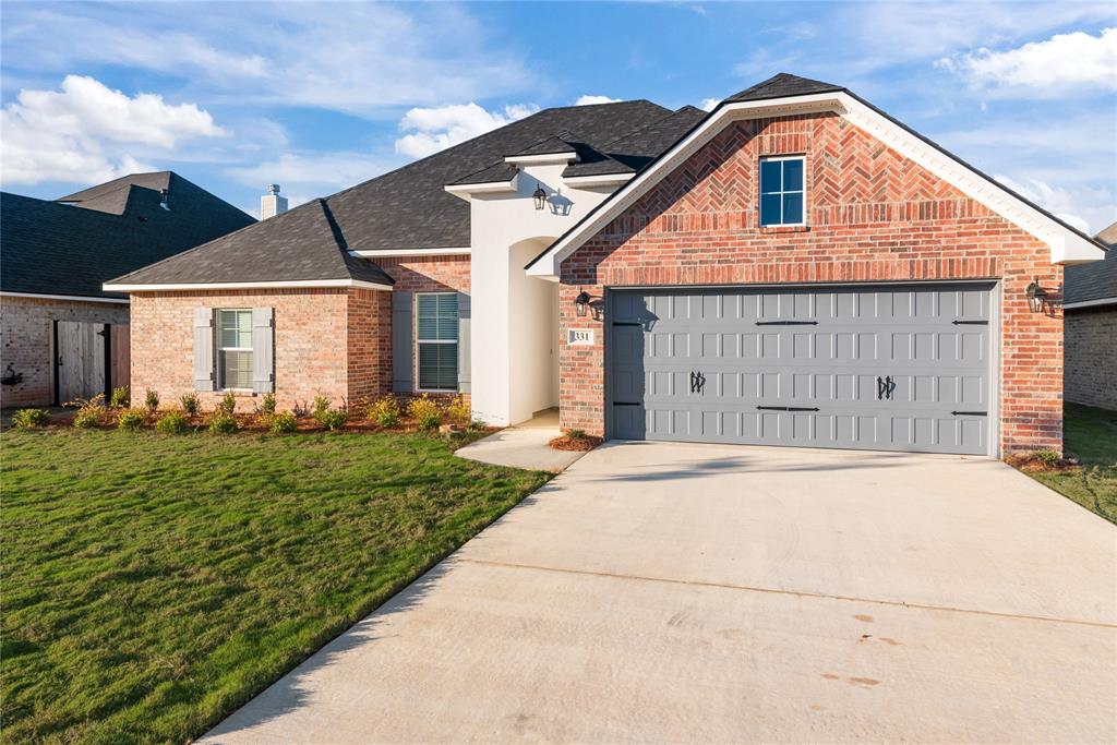 331 Prien Lk Loop Bossier City, LA 71111 - Photo 2 of 37 View of front of house featuring brick siding, driveway, a front lawn, and a shingled roof