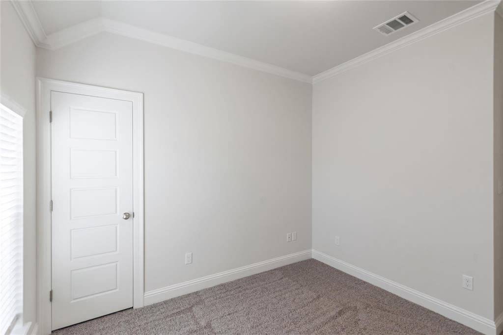 331 Prien Lk Loop Bossier City, LA 71111 - Photo 21 of 37 Carpeted spare room featuring crown molding and baseboards