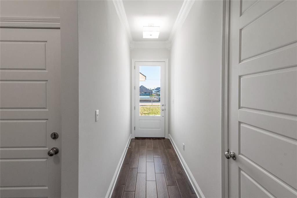 331 Prien Lk Loop Bossier City, LA 71111 - Photo 5 of 37 Doorway to outside with crown molding and wood finished floors