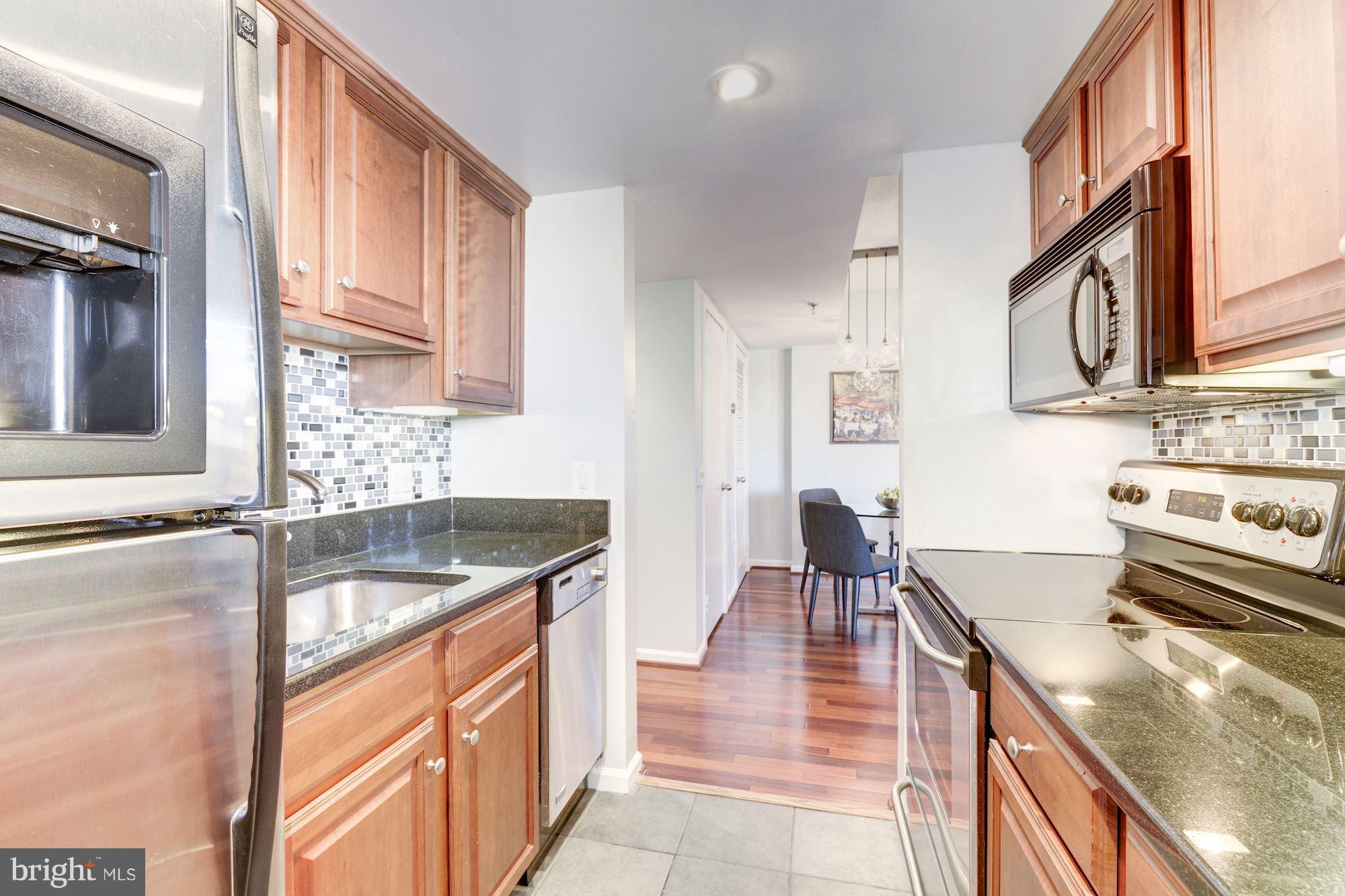 2311 M Street Northwest, Unit 1002 Washington, DC 20037 - Photo 11 of 29 Kitchen With New Tile Backsplash