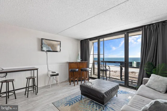 a living room with furniture and a floor to ceiling window