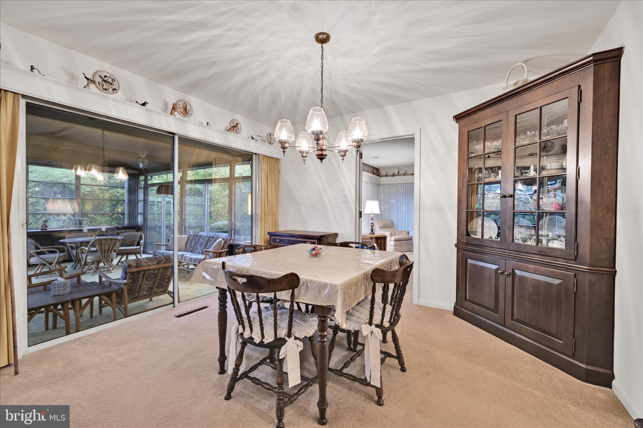 1451 Museum Road Wyomissing, PA 19610 - Photo 13 of 44 a view of a dining room with furniture large windows and wooden floor