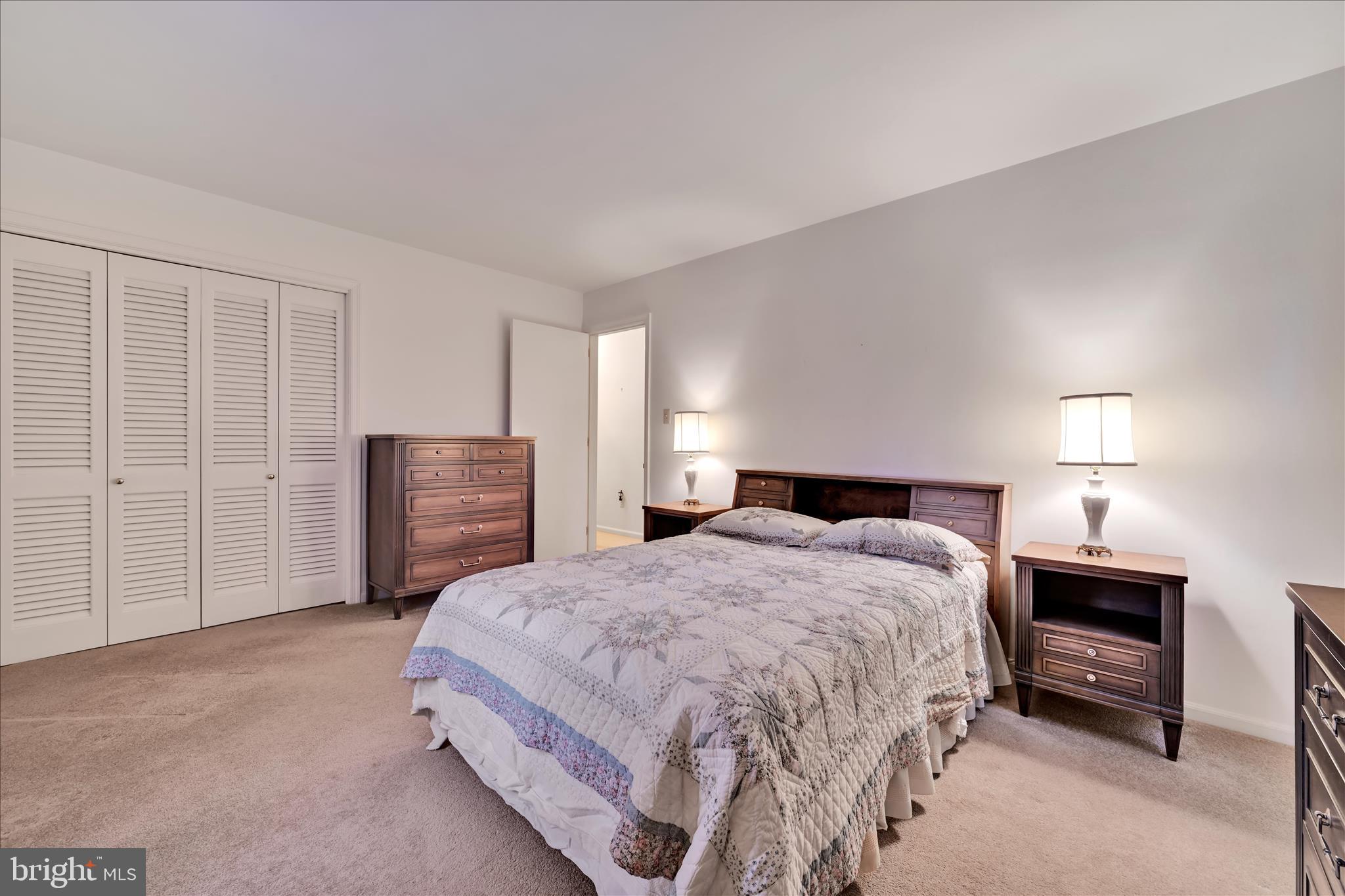 1451 Museum Road Wyomissing, PA 19610 - Photo 32 of 44 a spacious bedroom with a bed a dresser and a fireplace