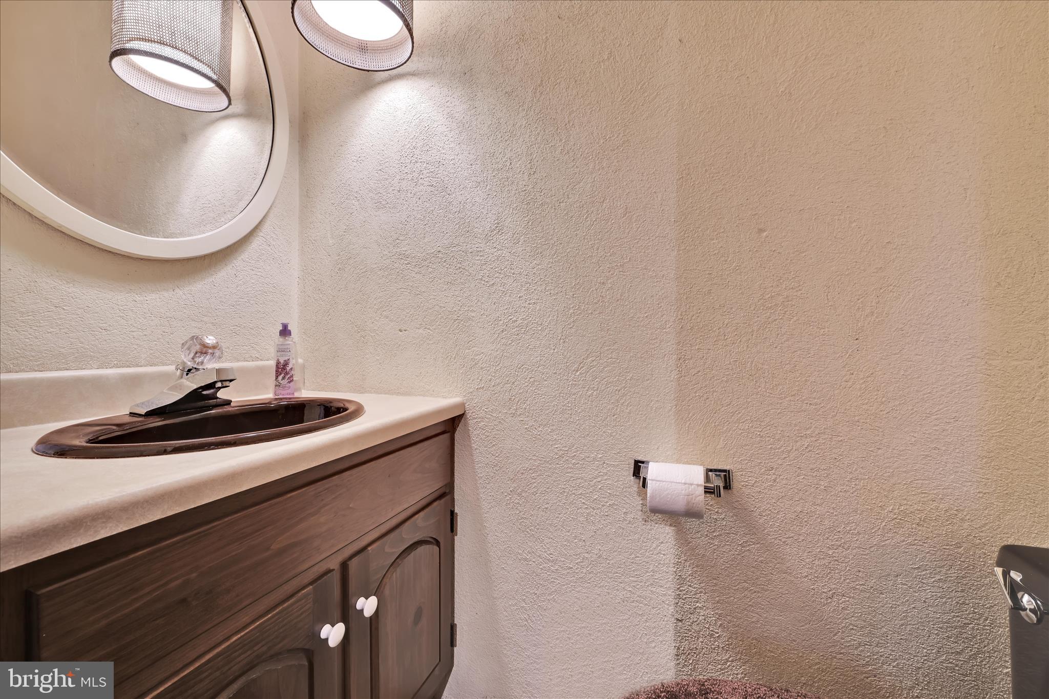 1451 Museum Road Wyomissing, PA 19610 - Photo 33 of 44 a bathroom with a sink and a mirror