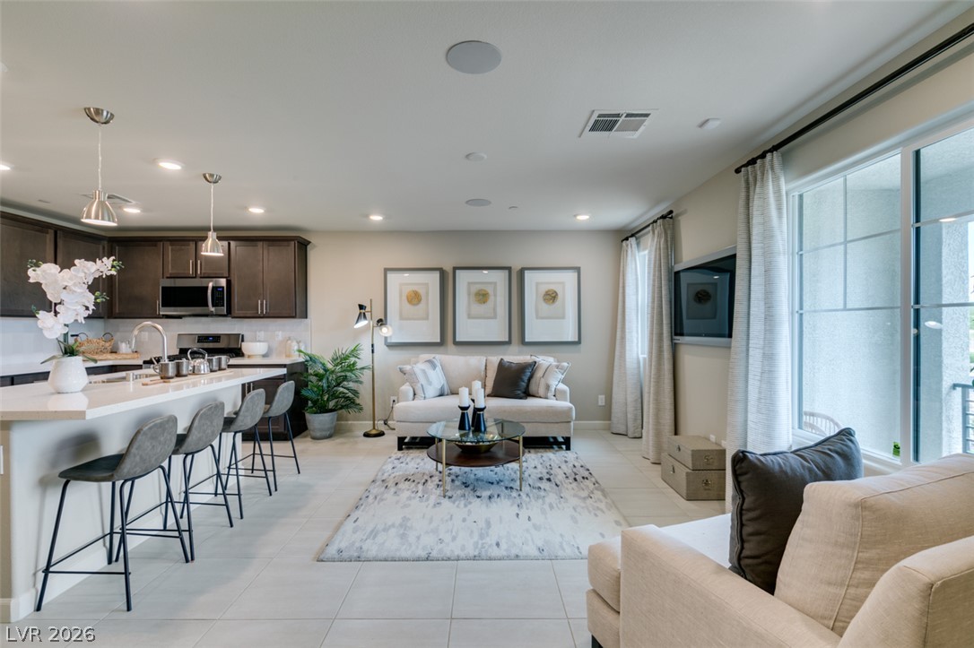 653 Pickled Pepper Place Henderson, NV 89011 - Photo 8 of 35 An open-concept living space integrates a well-appointed kitchen with inviting entertainment areas.