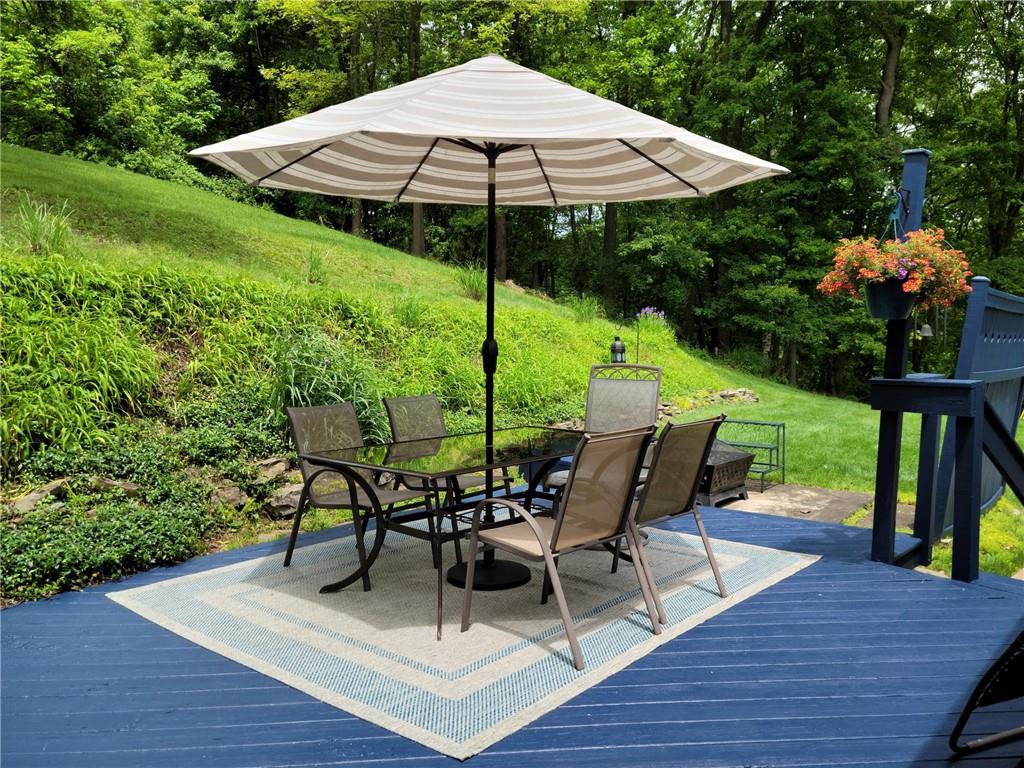 5184 Richland Road Gibsonia, PA 15044 - Photo 10 of 23 a view of a chairs and table under an umbrella