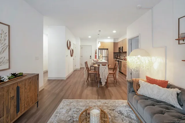 a kitchen with stainless steel appliances a sink a refrigerator a stove a microwave and cabinets