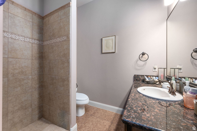 2376 Stone Crest Circle St. George, UT 84790 - Photo 44 of 61 Full bathroom with vanity, a tile shower, and light tile patterned flooring