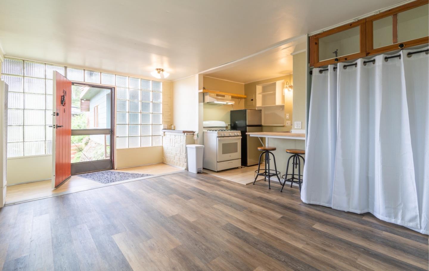 424 Belfast Avenue Pacifica, CA 94044 - Photo 5 of 11 a view of a kitchen with furniture wooden floor and a window