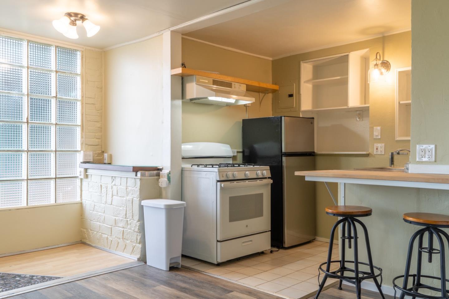 424 Belfast Avenue Pacifica, CA 94044 - Photo 6 of 11 a kitchen with appliances cabinets and a table