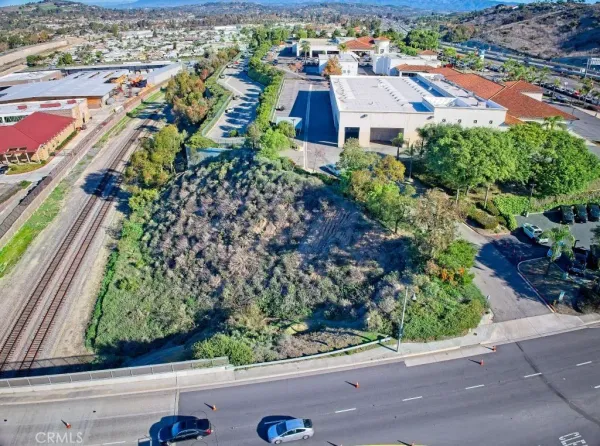 an aerial view of residential houses with outdoor space and street view