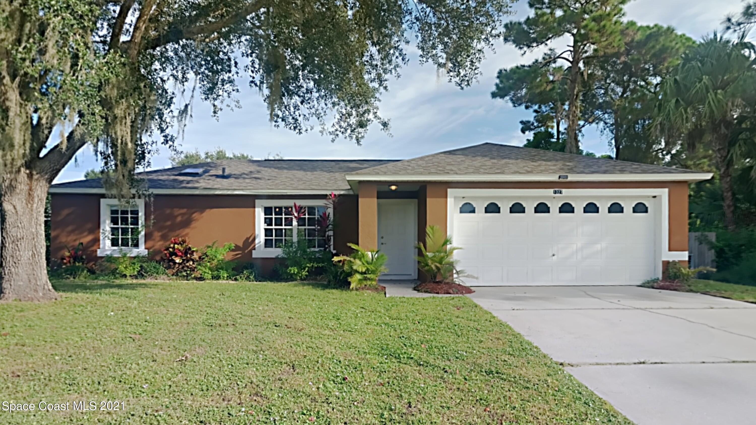 1327 Whitehurst Road Southwest Palm Bay, FL 32908 - Photo 1 of 21 front view of a house with a yard