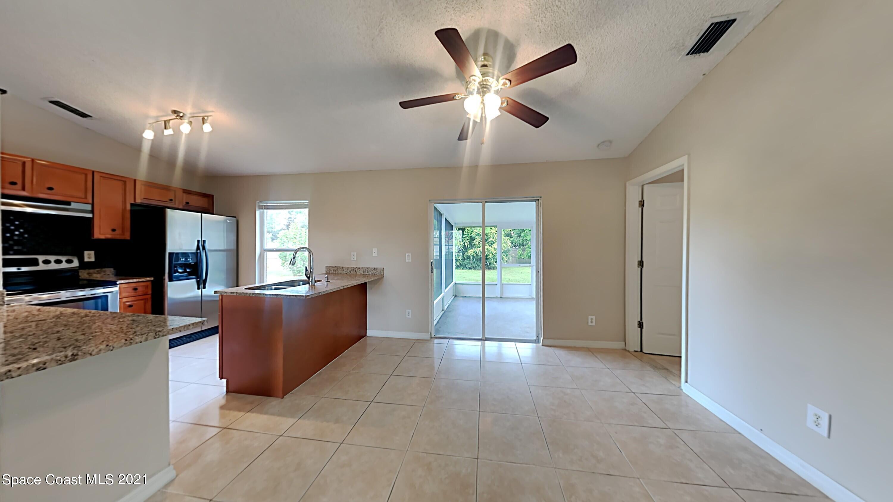 1327 Whitehurst Road Southwest Palm Bay, FL 32908 - Photo 2 of 21 a view of living room kitchen with furniture and a window
