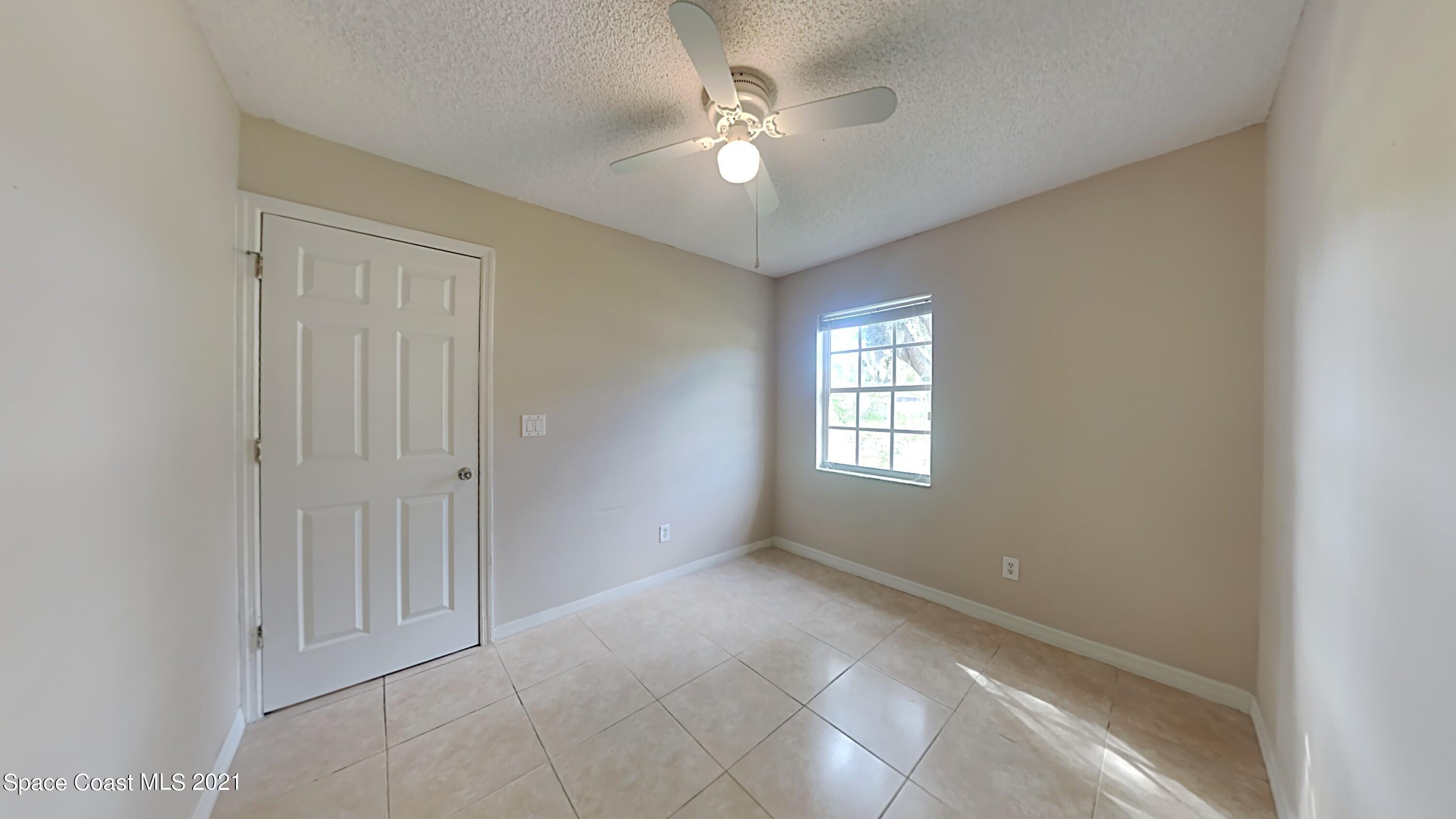 1327 Whitehurst Road Southwest Palm Bay, FL 32908 - Photo 15 of 21 a view of an empty room with a window