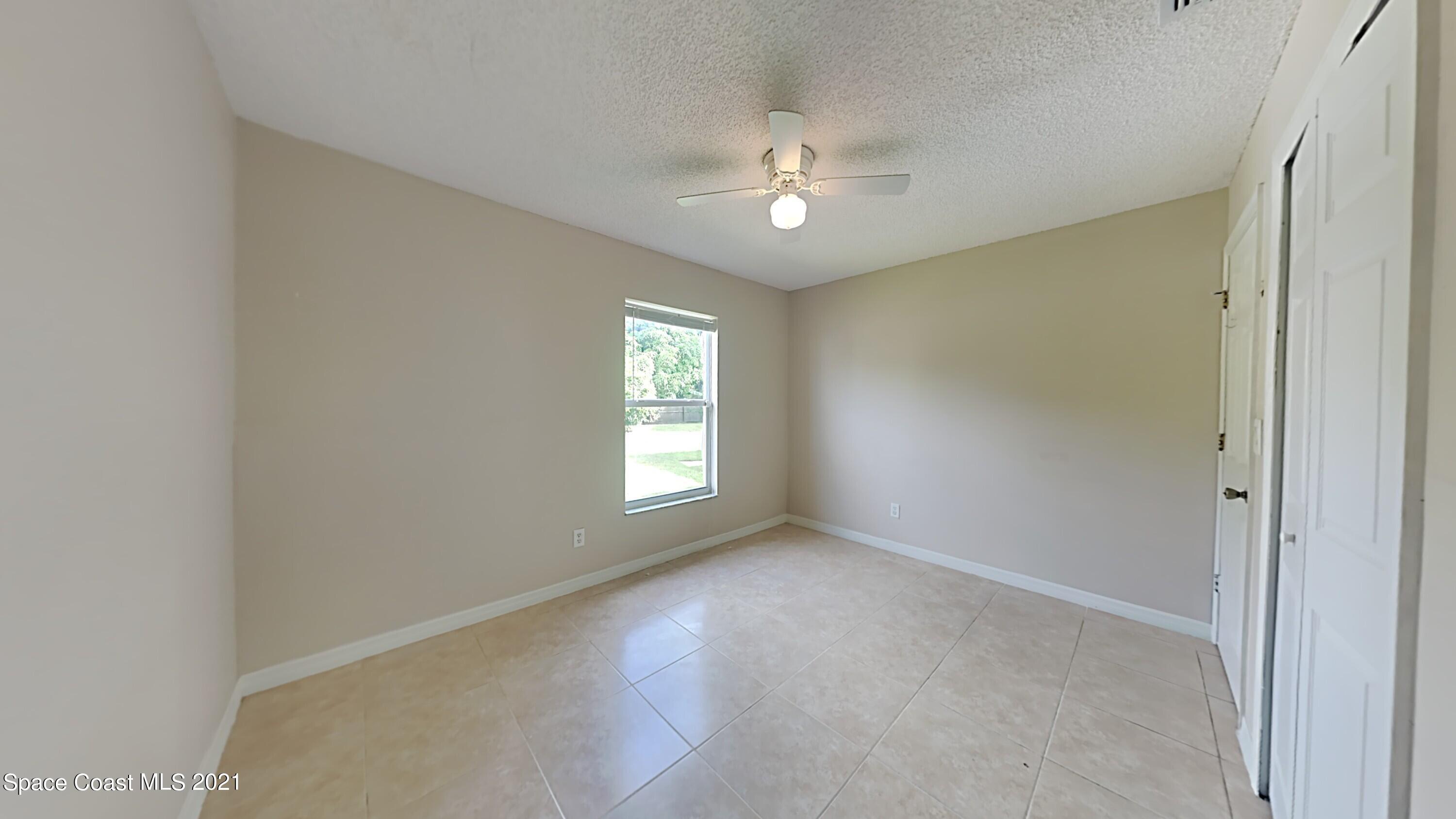 1327 Whitehurst Road Southwest Palm Bay, FL 32908 - Photo 17 of 21 a view of an empty room with a window