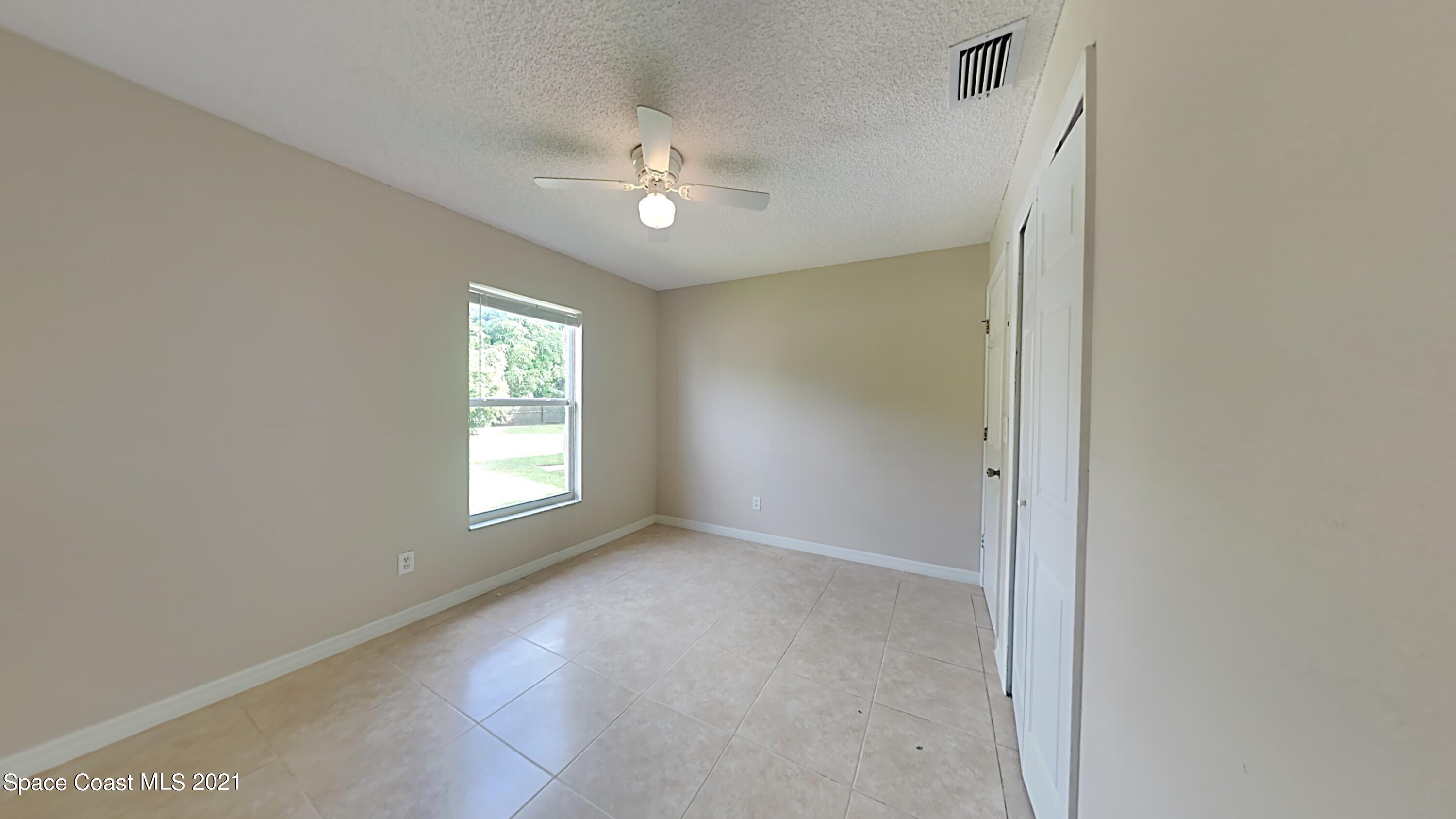 1327 Whitehurst Road Southwest Palm Bay, FL 32908 - Photo 18 of 21 a view of an empty room with a window
