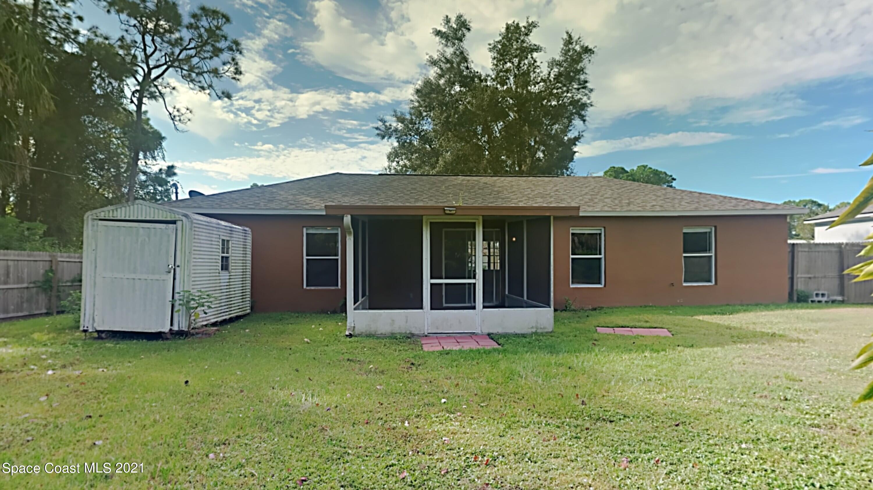 1327 Whitehurst Road Southwest Palm Bay, FL 32908 - Photo 20 of 21 a view of a house with a garden