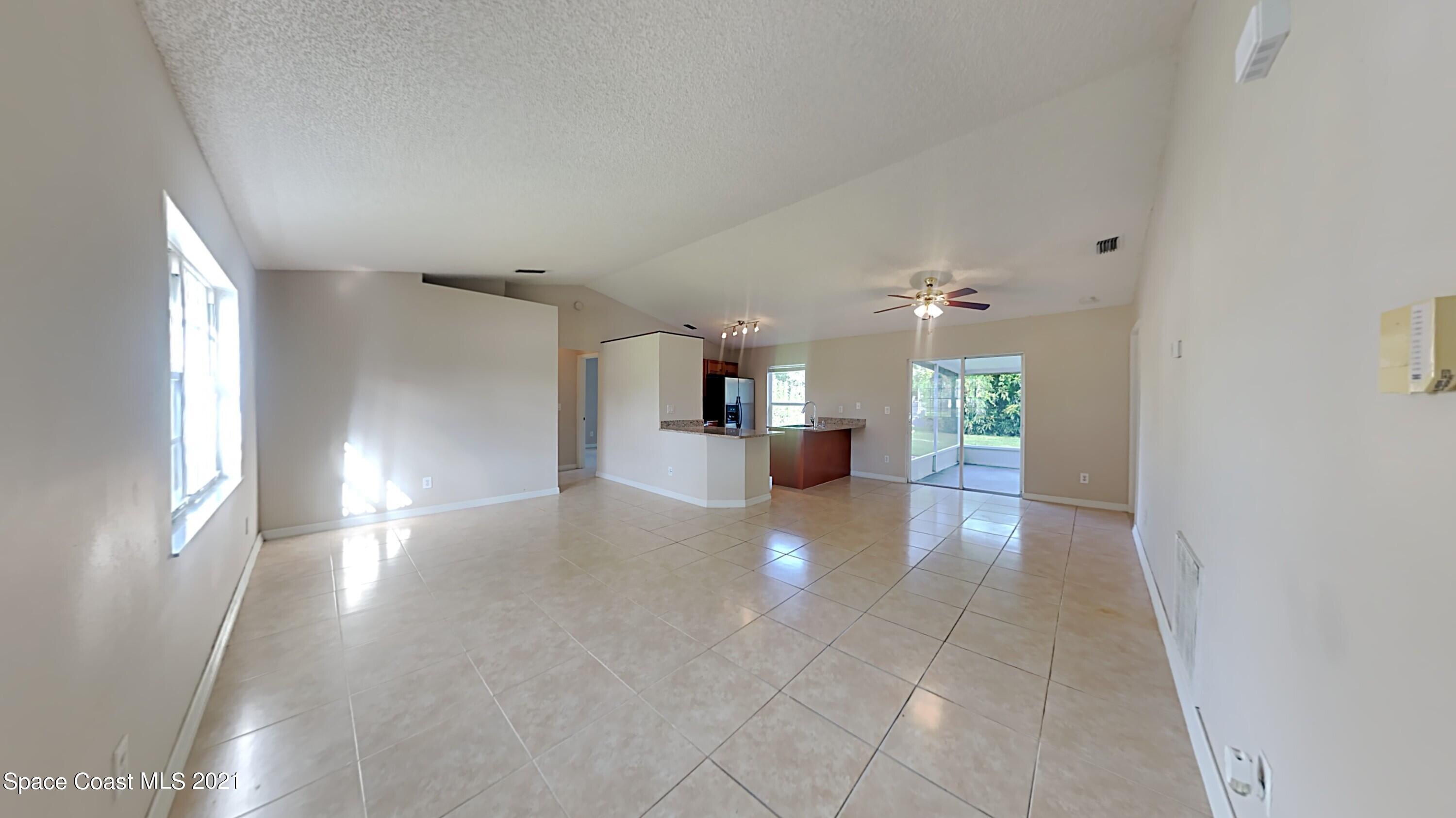 1327 Whitehurst Road Southwest Palm Bay, FL 32908 - Photo 5 of 21 a view of a kitchen with a sink and a window