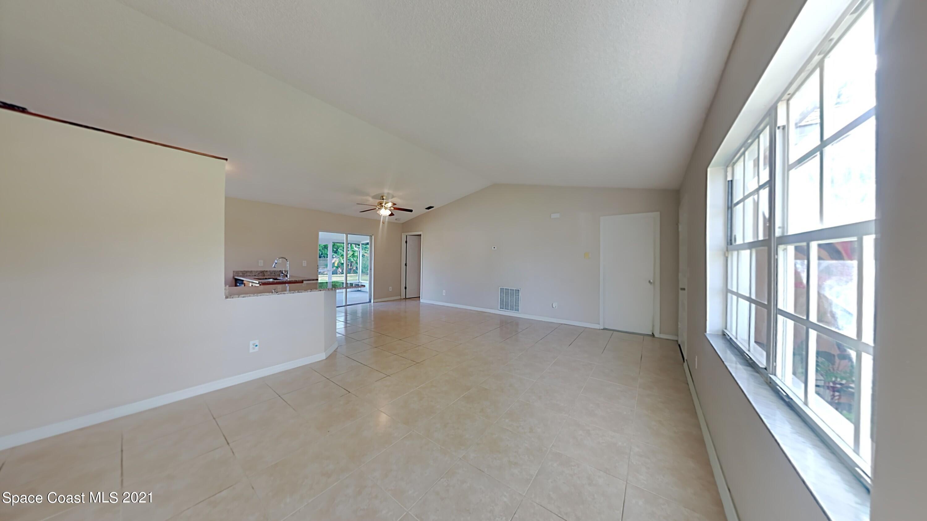 1327 Whitehurst Road Southwest Palm Bay, FL 32908 - Photo 6 of 21 a view of a big room with windows and entryway