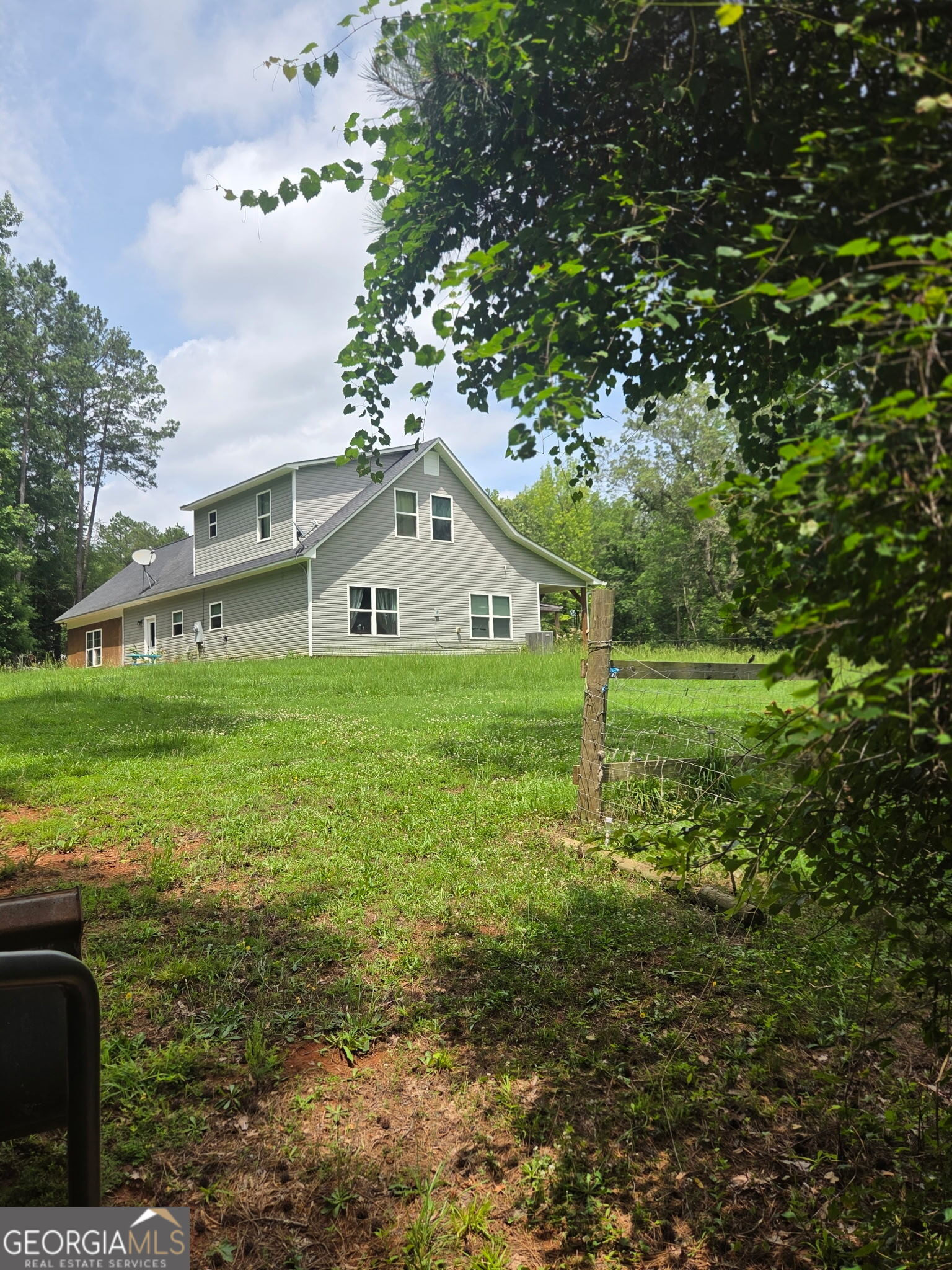 408 Bowen Road Milner, GA 30257 - Photo 4 of 36 a view of a house with yard and sitting area