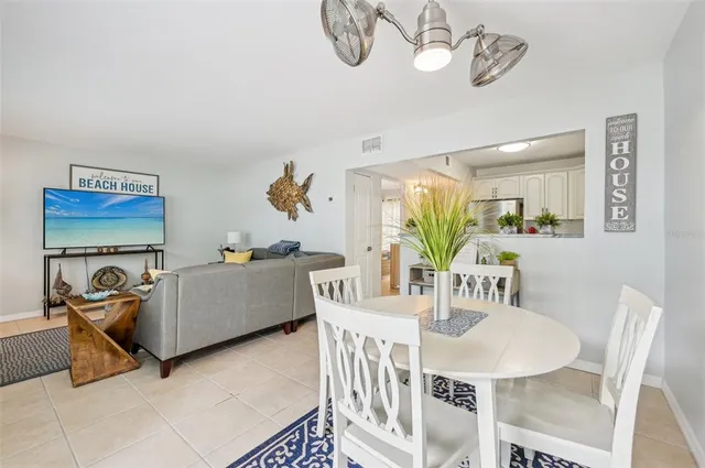 a dining room with furniture and a chandelier