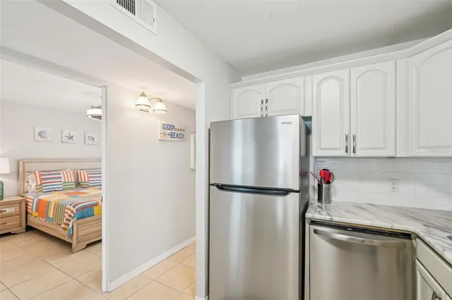 a kitchen with stainless steel appliances granite countertop a refrigerator and a stove