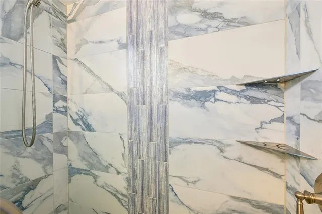 a bathroom with a bathtub and shower