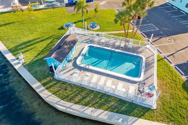 a view of a swimming pool with a yard and sitting area