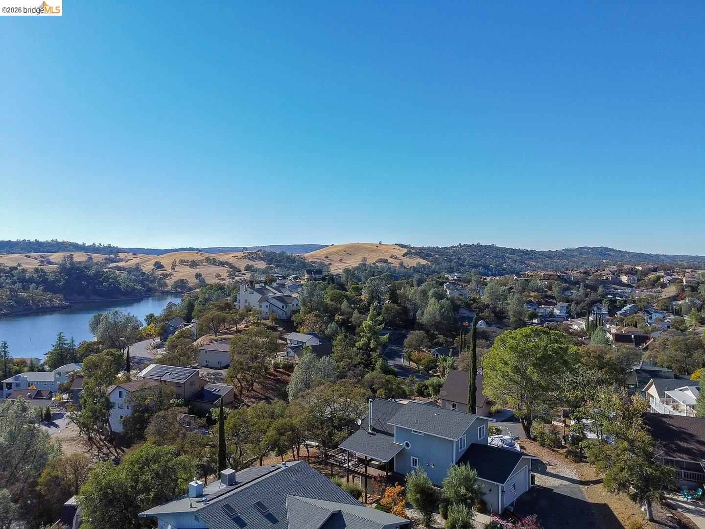 501 Indian Hill Road Copperopolis, CA 95228 - Photo 7 of 10 Expansive residential area featuring a prominent water body, rolling hills, and mature trees