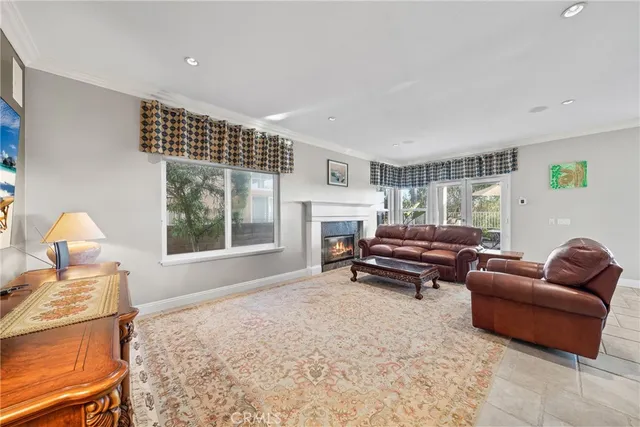 a living room with furniture a window and a fireplace