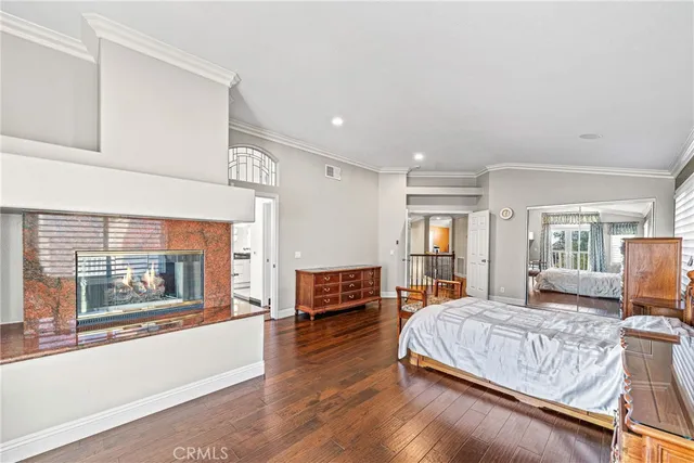 a bedroom with a large bed and a large window