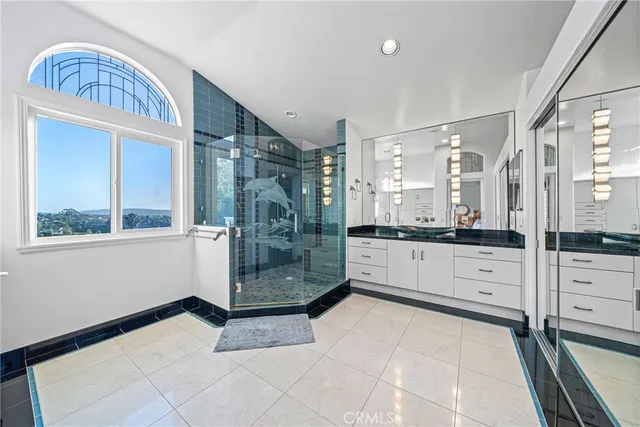 a large white bathroom with a granite countertop sink mirror and bathtub