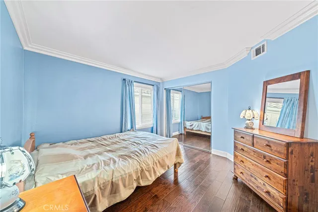 a bedroom with a bed and a large window