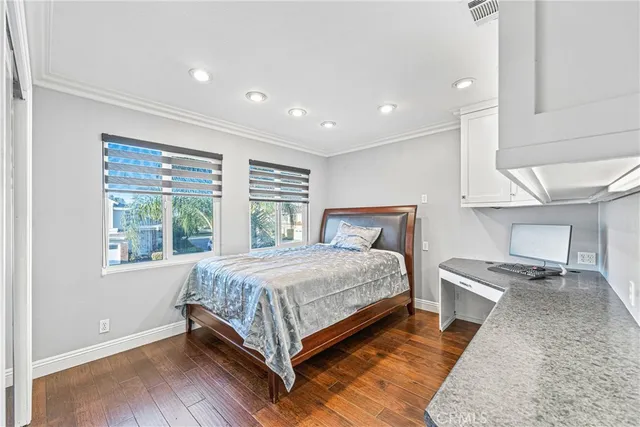 a bathroom with a granite countertop sink a toilet a mirror and bathtub